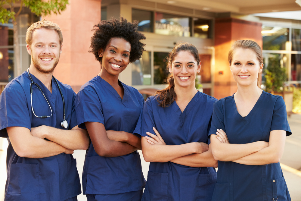 Team of healthcare professionals in blue scrubs
